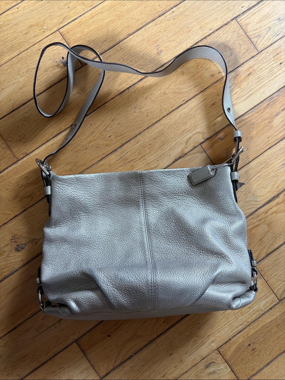Coach F15064 metallic silver pebbled leather hobo crossbody bag.